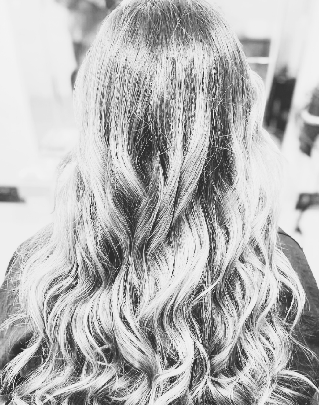 Imogen, our apprentice stylist, smiling in the Stourbridge salon as she gains hands-on experience in hairdressing.